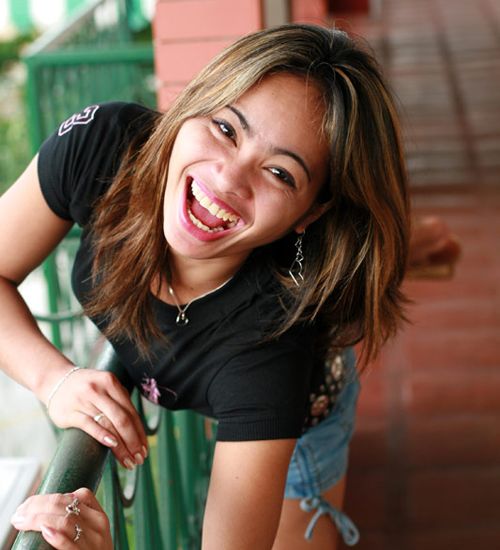 Hot Filipina Coed lying around sticking out her naughty tongue while she gets undressed in the bedroom.