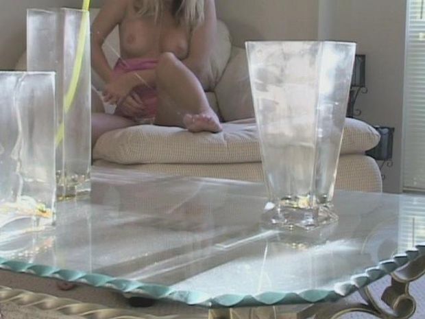 Cute blonde gets secretly filmed while undressing in her living room