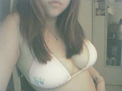 Sexy young babe taking hot sexting pics of herself in front of the mirror... nice tits too!