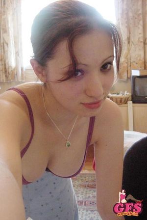 Brunette teen GF taking a picture of her big boobs in bra