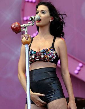 A goddess gently masturbates on stage.