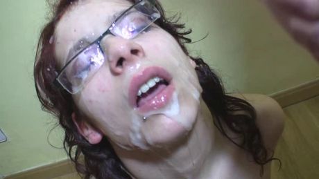 Busty redhead with glasses receives a cumbath