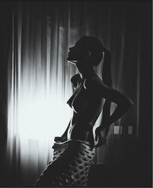 Hot brunette with ponytail in silhouette