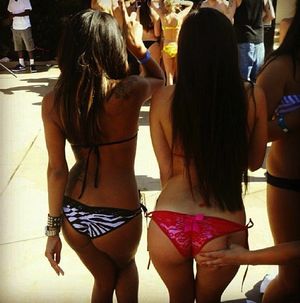 two sluts dancing and showing off their perfect asses at a party