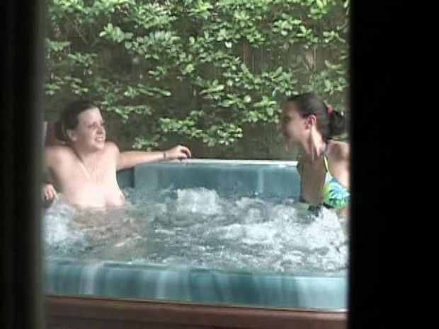 Checking out the neighbors in the hot tub topless!