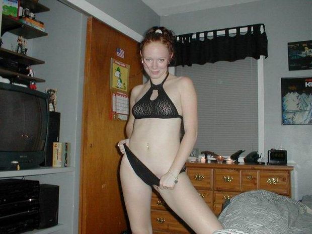 Cute redhead takes a photo of her self in her room