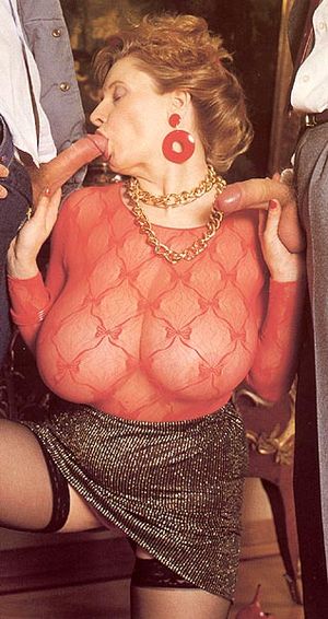 Two cocks to satisfy her mouth and pussy! Two loads of ball nut will soon cover her face and drip all over her!