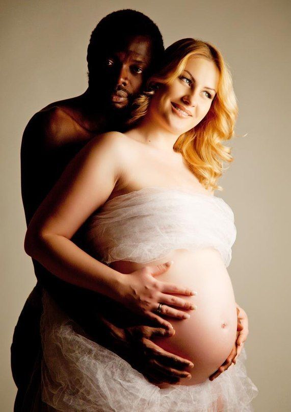 She's aglow with happiness ready to give birth to her first black baby! He can't help squeezing her white belly!  Very lucky girl!