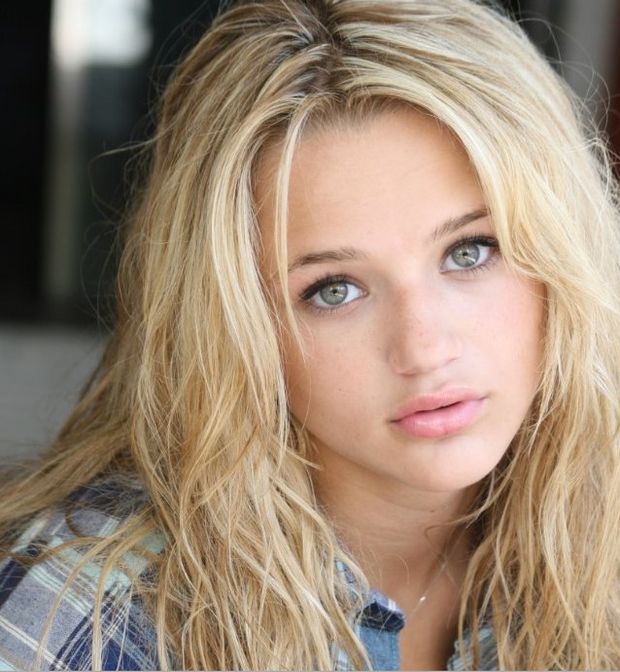 Blonde girl with green eyes looking cute
