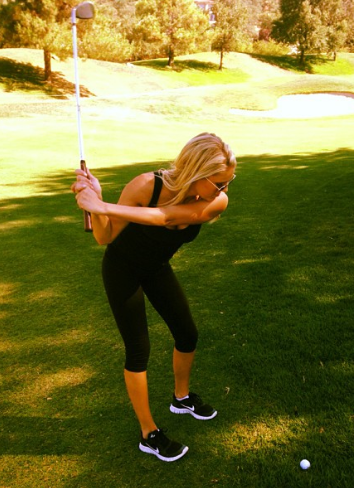 sexy girl in yoga pants golfing