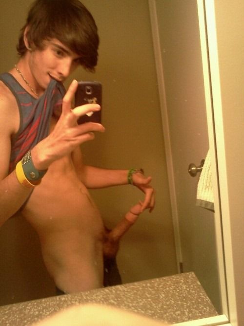 Cute twink in the bathroom holding his tip