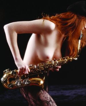 Sexy Lil Thang With A Flaming Red Mane And Creamy White Skin Blowin Her Mean Sax, Topless Of Course.....