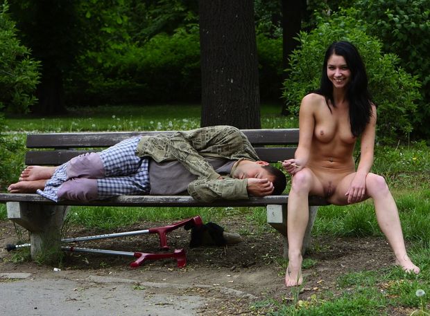 Posing with a sleeping guy on a park bench