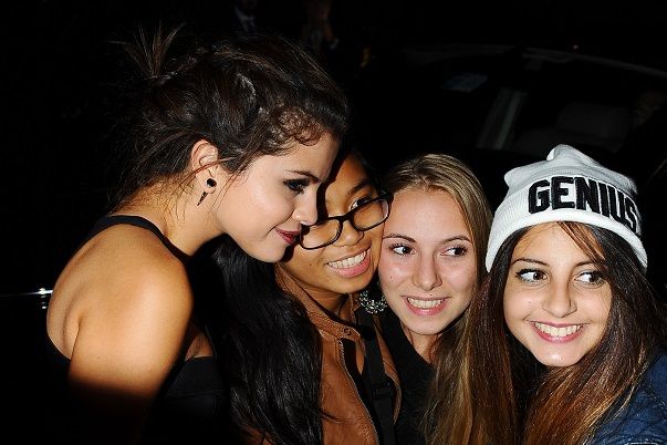 selena gomez poses with fans