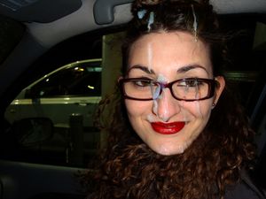 Girl with bright red lipstick driving in the car with cum all over her face and hair