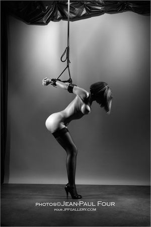 Tied blindfold babe in highheels and rope arm restraint
