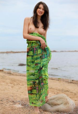 Tall russian brunette with big boobs posing n the beach