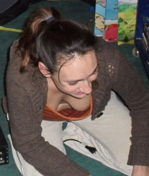 Slut bending over and letting her nipple be seen