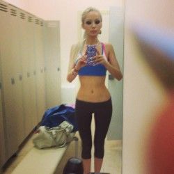 Valeria Lukyanova in gym locker room fully clothed