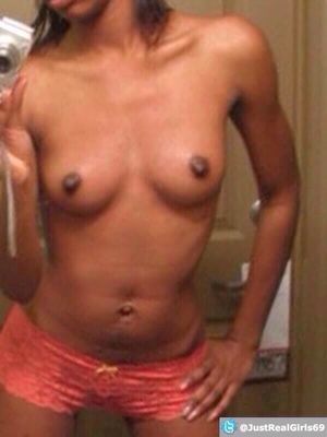 Faceless ebony teen self-shot in boy shorts