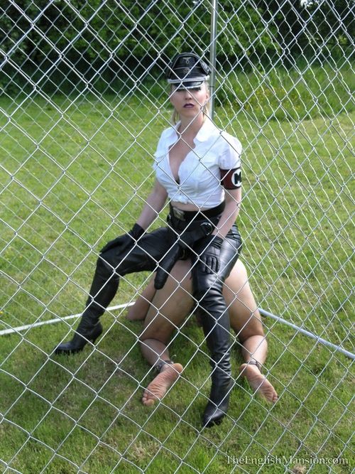 Mistress Sidonia uses her huge black strapon to fuck the caged slave.