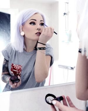 hot! lavender haired glam-punk putting on her makeup