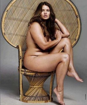 Curvy, BBW girl looking cute and sexy in that Huey P. Newton-style wicker throne chair!