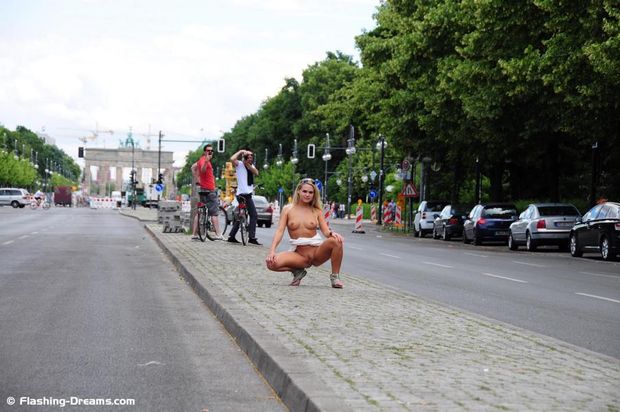 Blonde spreading legs on public street
