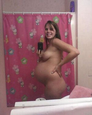 cute, young pregnant chick takes selfie in the mirror