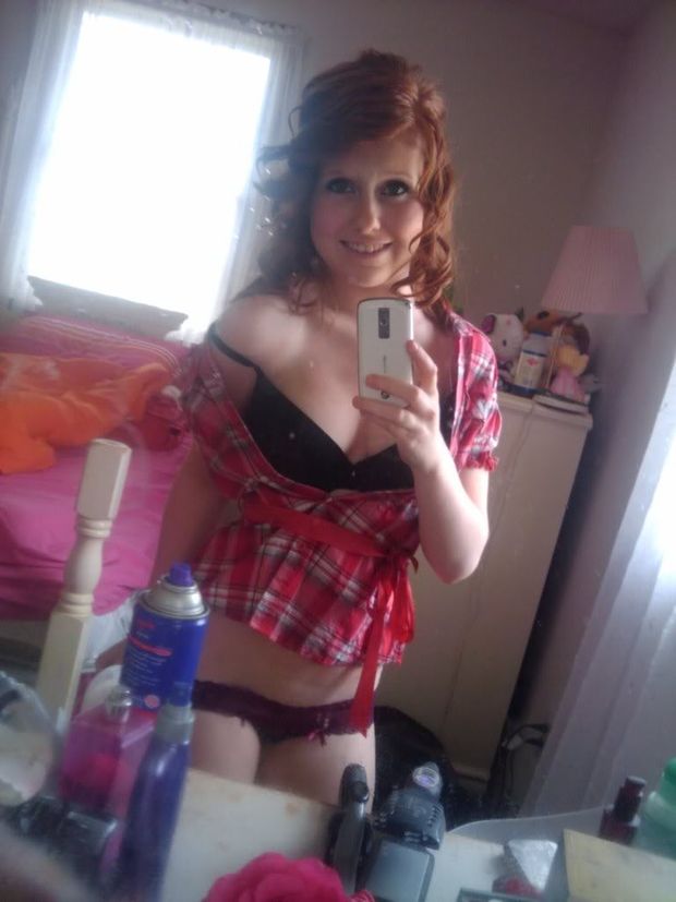 Youg and cute redhead dressed sexy taking a selfie