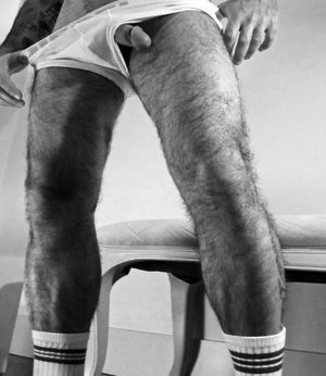 Hairy legs and a dick slipping out of underwear