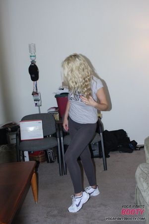 Emily Austin stretches wearing yoga pants in her house