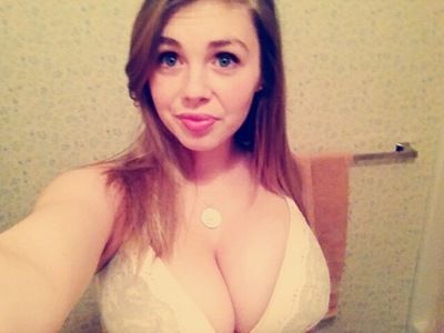 Selfie of lovely big brunette breasts in white bra