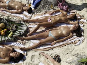girls sunbathing topless on the beach