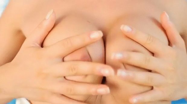 Stroking her boobs