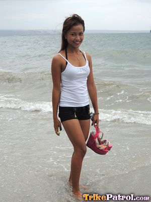 Cute Asian teen in short-shorts on the beach