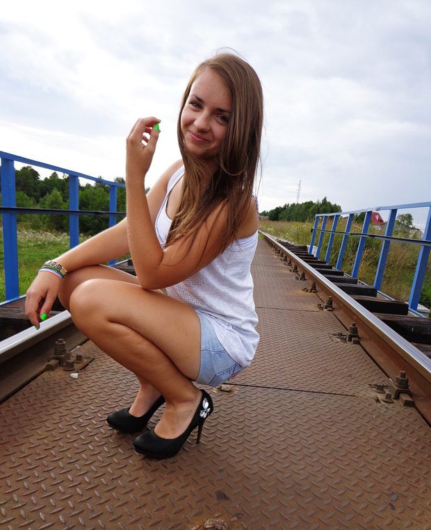 Hot legs squatting on a bridge