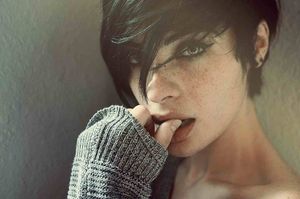 Girl with short hair, freckles, and beautiful eyes.