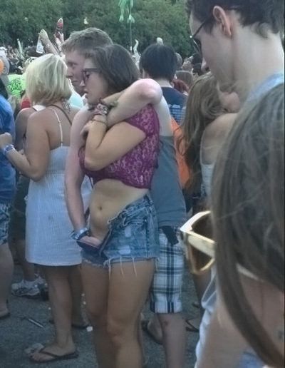 As her legs tremble he holds her up while she cums in front of everyone at the concert.