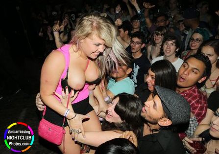 Tits pop out on stage at the club.