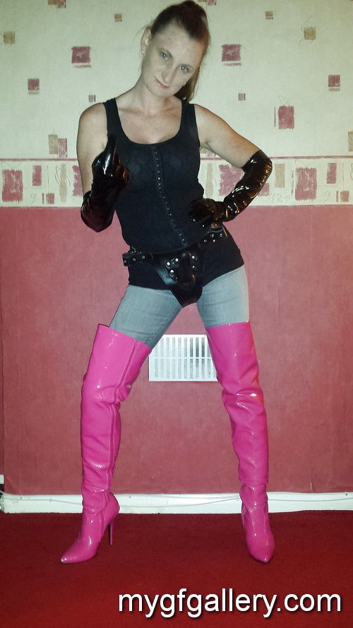 Strapon wearing mistress in pink thigh high boots