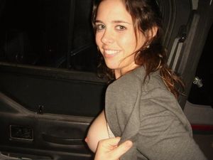 Beautiful girl pulling up her shirt