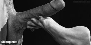 Stroking big cock with her sexy feet