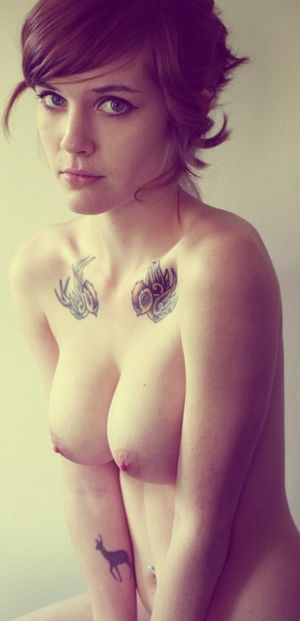 Beautiful tattooed brunette with short hair