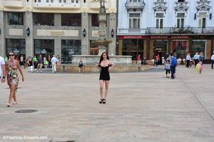 Brunette teen in sexy dress showing her tits in public