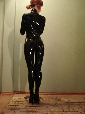 Backside view of woman in latex suit