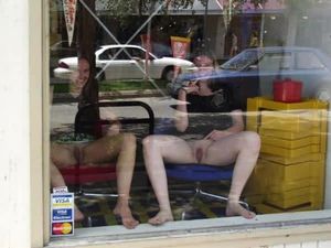 two trimmed amateur brunettes showing of in the window