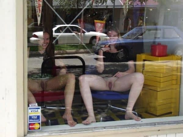 two trimmed amateur brunettes showing of in the window