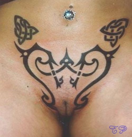 shaven tattooed fanny in close up
