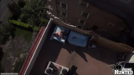 Beauty Jeniffer gets caught by Drone fucking at a rooftop with a guy at bar. She offers her pussy with delight and the guy fingers her with